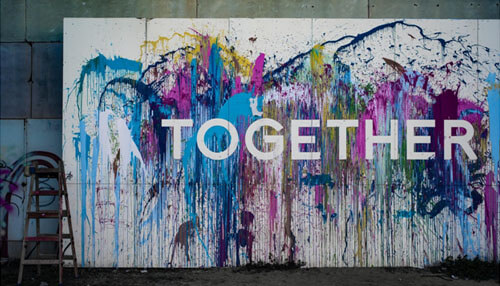 A picture of the word together painted onto a wall community