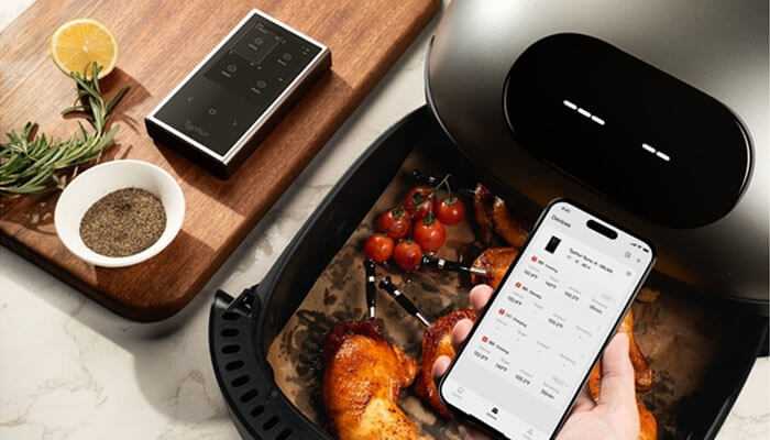 Smartphone app to monitor cooking via wireless meat thermometers inside an air fryer-all intelligently integrated into your home.