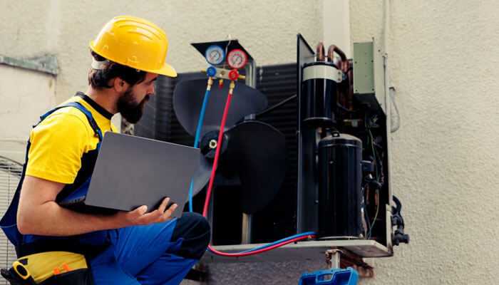 An hvac technician is inspecting the cooling unit outside the kitchen, focusing on hvac issues its repair and maintenance to ensure proper operation