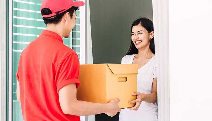 Customer receiving a discreet package from a reliable weed delivery service at their doorstep, showcasing convenience, professionalism, and customer satisfaction.