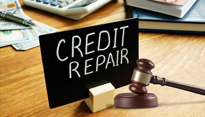 Credit repair and real estate lawyers with credit repair sign and gavel on a desk, symbolizing the legal aspects of building a strong financial foundation and improvement