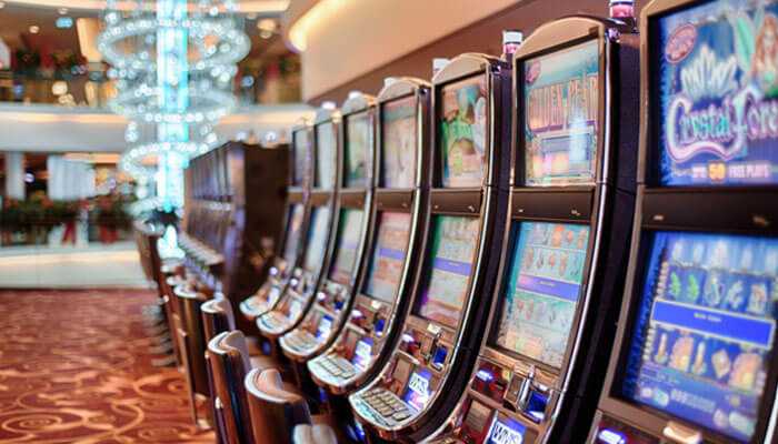 Row of slot machines in a casino, illustrating opportunities for winning big prizes in online football betting through strategic gameplay