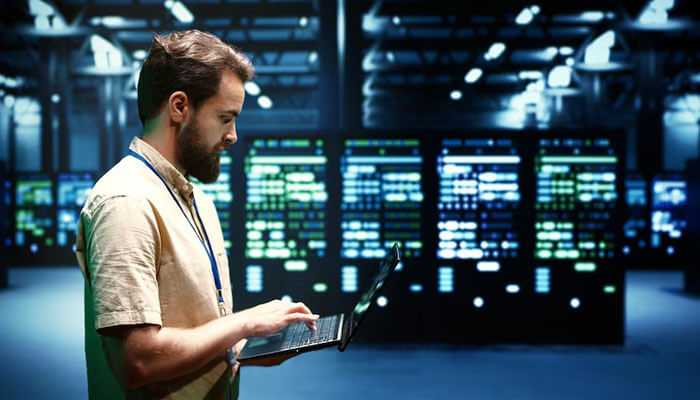 It professional working on a laptop in a server room, representing caching in cdn performance, showcasing how caching enhances speed, reduces latency, and optimizes resources