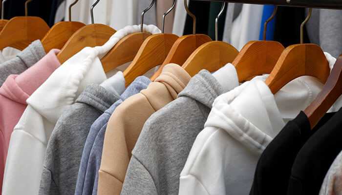 Hoodies in various colors on hangers are perfect inspiration to start a hoodie business.