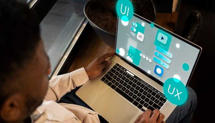 Scale your software product with a focus on ui/ux design, as a person works on a laptop displaying interface mockups and design elements