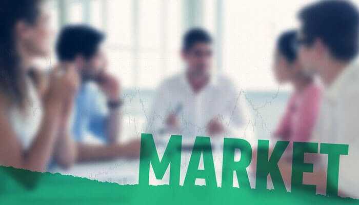 A team of professionals discussing market strategies, focusing on building a thriving business, with the word market overlayed.