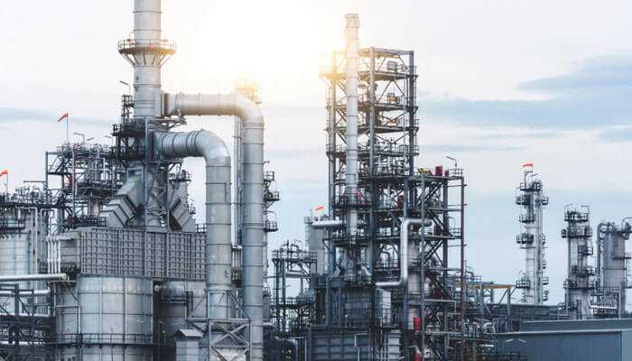 Oil refinery of oil and gas, note the steel pipelines to display advanced infrastructure in the u. S. Energy sector, under clear skies.