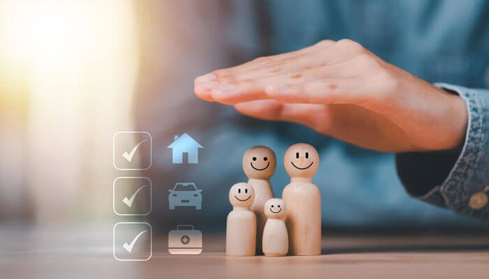 A hand protecting wooden family figures, symbolizing insurance coverage for home, auto, and travel. Slip and fall lawsuits involve injury claims due to unsafe property conditions.