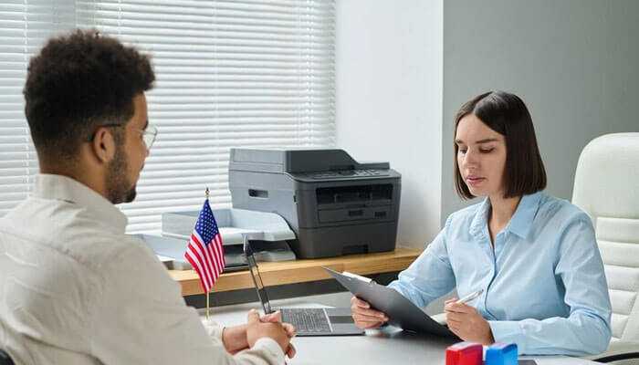 A professional consultation in the office, representing recruitment agencies in usa, with an american flag on the desk.