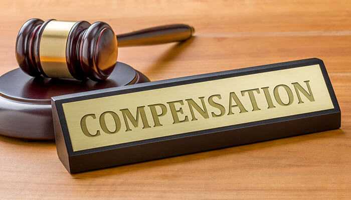 Portland car accident lawyer : the image shows a gavel and a "compensation" sign, representing a