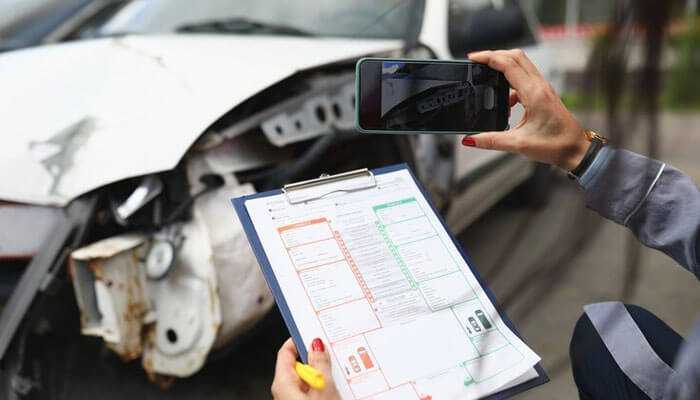 Documenting a truck accident in santa fe with a clipboard and smartphone, capturing vehicle damage for evidence