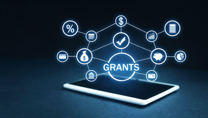 Financial relief options: a hologram of'GRANTS' with dollar signs and charts floating above a tablet, symbolizing digital funding opportunities