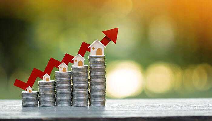 Real estate ownership and income showing growing investments with stacked coins, houses, and an upward arrow