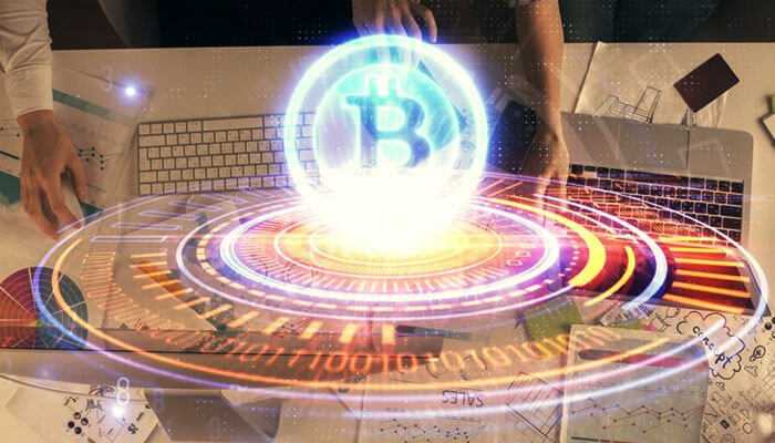 A glowing bitcoin symbol above a desk with charts and computers, highlighting online activities with crypto adoption.