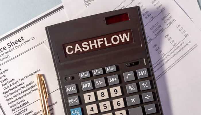 Hire an accountant – calculator displaying'CASHFLOW' on financial documents, emphasizing the importance of professional accounting for business success.