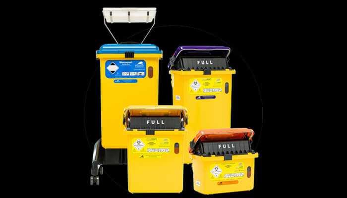 Multiple yellow hospital waste bins labeled for different types of medical waste, emphasizing proper segregation in hospital waste disposal to avoid common violations.