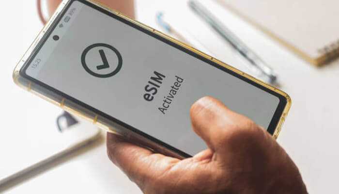 Person holding a smartphone showing'eSIM Activated' on the screen, symbolizing the convenience of eSIM for free international data.