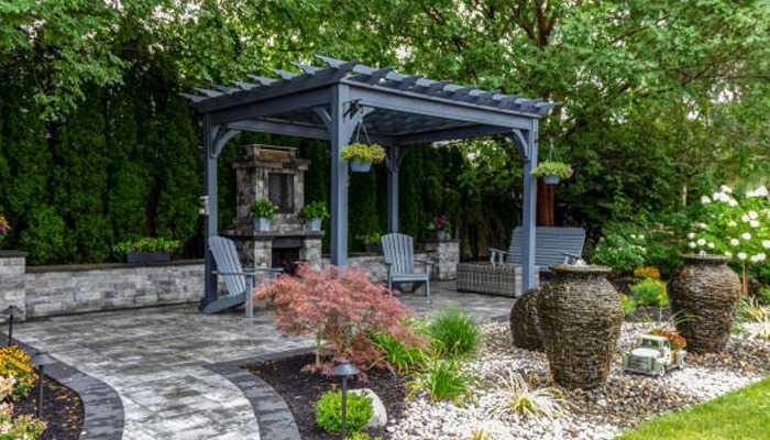 Gazebos and marquees offering a stylish outdoor retreat with a beautiful pergola, comfortable seating, and lush greenery.