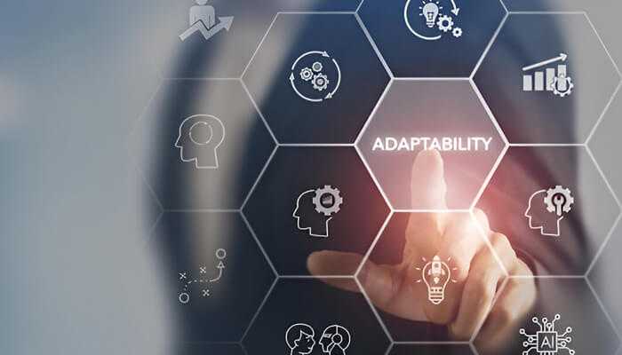 A business leaders finger pointing at a digital interface highlighting the word "adaptability," surrounded by icons representing innovation, leadership, and growth.
