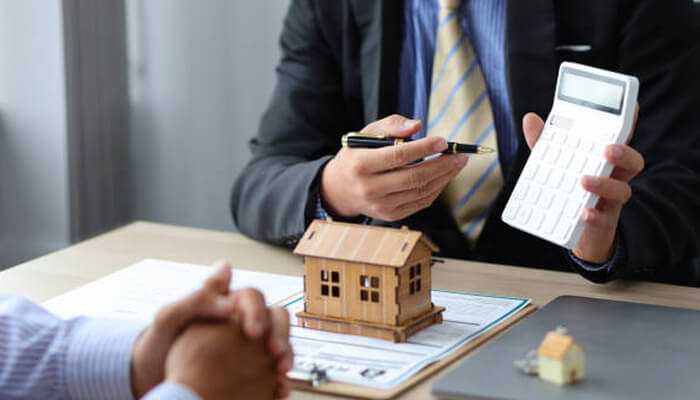 Young couple reviewing financial documents on a laptop while applying for a mortgage in canada during their home-buying process.