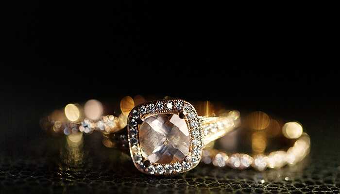 Elegant halo-set engagement ring from rare carat with a square-cut center diamond and pavé band, symbolizing timeless beauty and style.