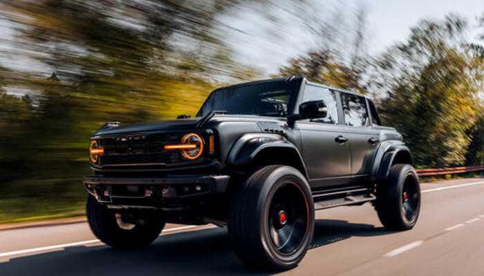 Classic ford bronco speeding down a highway, highlighting its bold performance and modernized vintage appeal.
