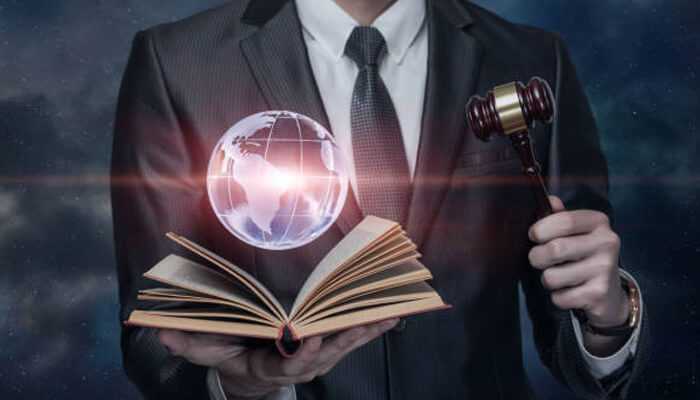 Digital transformation of legal education illustrated by a businessman holding a gavel, open book, and a glowing virtual globe.