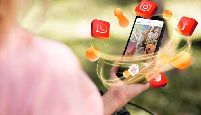 Hand holding phone with glowing social media icons, highlighting visual impact on digital marketing results.