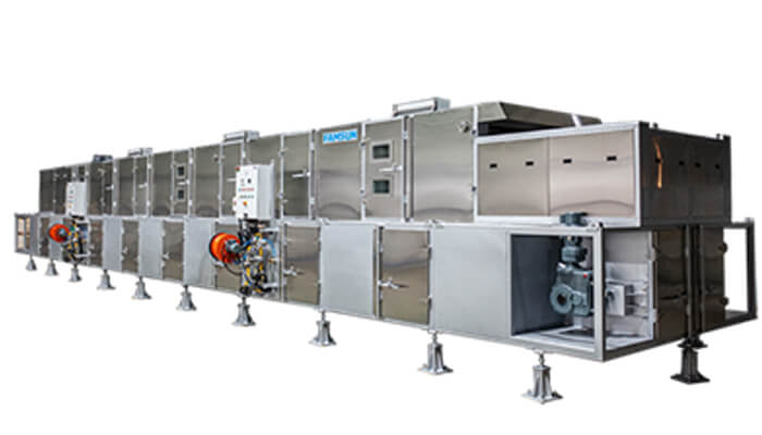 Industrial extruder machine used in pet food production, illustrating the manufacturing process comparison in baked vs extruded dry pet food.
