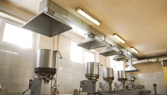 Industrial dust extractors and ventilation hoods installed in a food processing facility to ensure clean air and safe working conditions.