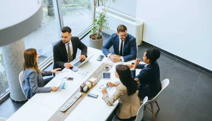 Leadership team engaged in a strategic discussion, highlighting teamwork and executive decision-making in a corporate setting.